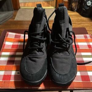 All black adidas tubular sneakers